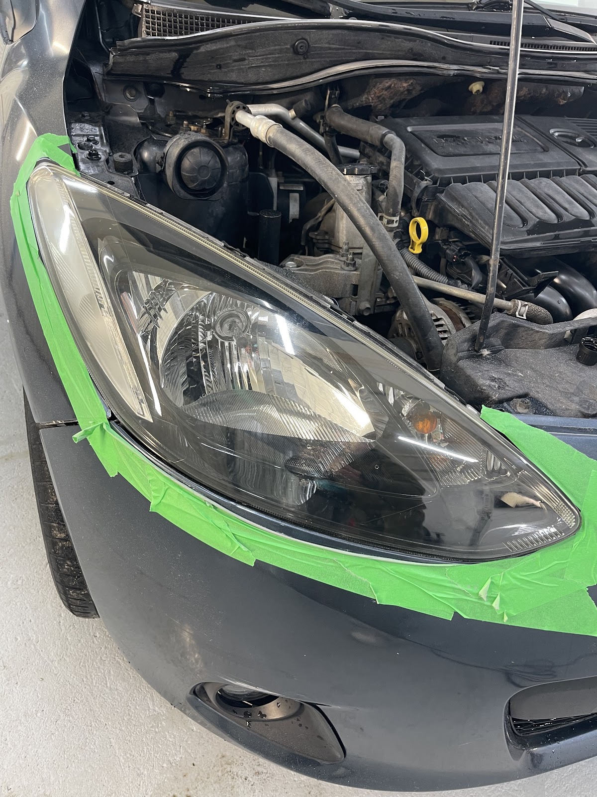 Shiny black car paint reflecting the sky